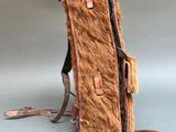 a brown bag with fur on it sitting on a table