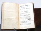 an old book with writing on it sitting on a table