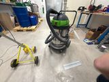 a vacuum that is sitting on the floor in a room