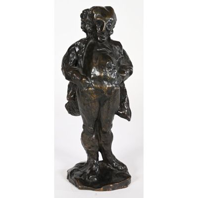 a bronze statue of a boy holding a bag