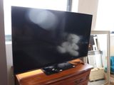 a flat screen tv sitting on top of a dresser in a living room