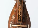 an old musical instrument that is sitting on a stand