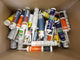 a cardboard box filled with different types of glues