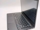 a laptop that is open on a white surface