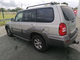a silver suv that is parked on the side of the road