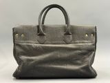 a grey leather handbag on a white background
