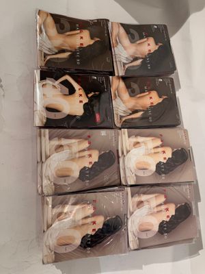 several boxes of sex products on a table with a cup of coffee in front of them