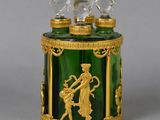 a green glass box with a gold decoration on it
