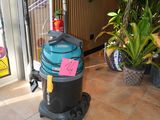 a vacuum that is sitting on the floor in front of a door