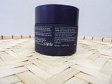 a close up of a jar of cream on a woven basket