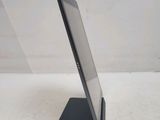 the tablet is sitting on a stand on a white surface