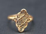 a close up of a gold ring on a black surface