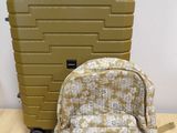 suitcase and backpack sitting on a table next to each other