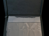 a open suitcase that has a sheet of paper inside of it