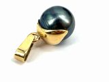 a close up of a black pearl with a gold clasp