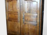 an image of a wooden armoire with two doors on each side