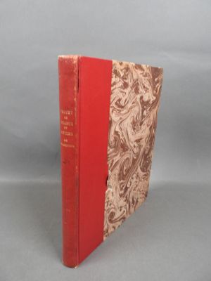 two red books sitting on top of each other on a gray surface