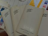 several papers are stacked on top of each other on a table