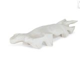 a white sculpture of a turtle on a white background