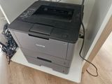 a black and white printer sitting on top of a white shelf