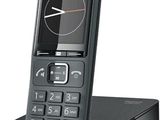an image of a black cell phone sitting on top of a stand
