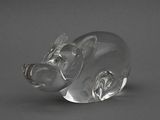 figurine de cochon en verre transparent posée sur une surface grise