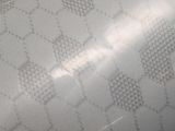 an image of a close up of a person ' s hand holding a white purse
