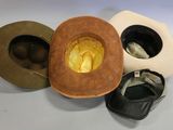 three hats and a pair of shoes are sitting on a table