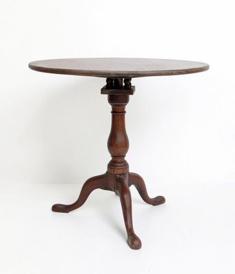 an old wooden table with a wooden top and a wooden base