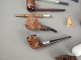many different types of smoking pipes on the table