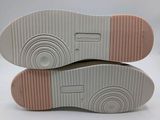the soles of a pair of white and pink sneakers