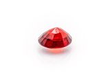 a close up of a red diamond on a white surface