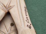 a figurine of a woman with a tattoo on her arm