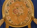 a gold chair with a floral pattern on it