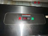 a black oven with a digital display on it