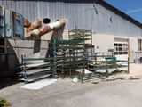 a large pile of pipes and pipes in front of a building