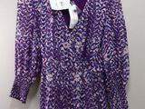 a close up of a purple and white dress on a hanger