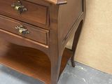 a small wooden table with two drawers on it