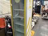 a refrigerator in a warehouse with a box on top of it