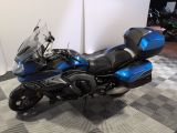 a blue and black motorcycle parked on a checkered floor