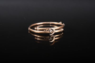 a close up of a gold ring on a black surface