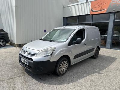 the silver van is parked in front of a building