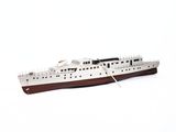 a small model of a boat on a white surface