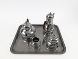 a silver tray with a silver tea set on it