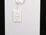 a white card with a white ribbon and a tag on it