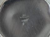a close up of a silver plate on a table
