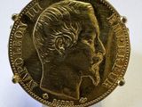 gros plan d'une pièce d'or sur laquelle figure le visage d'un homme