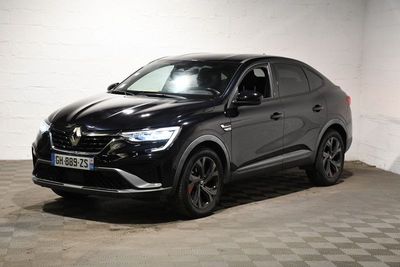 the black car is parked in the garage on a checkered floor
