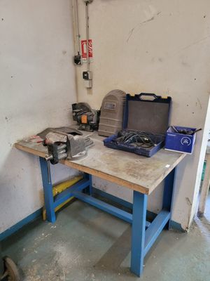 a workbench in a garage with tools on it