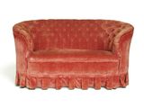 a red couch with a ruffled skirt on it